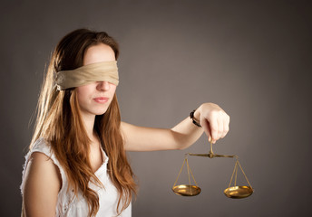woman holding a justice scale