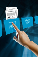 a finger of a woman, selects and opens a folder
