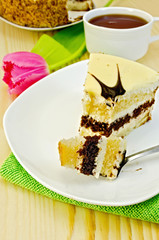 Cake with pink tulips on a wooden board