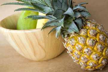 pineapple with wooden bowl