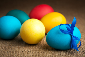 decorated colored Easter eggs on the burlap