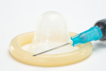 Rolled up condom and hypodermic needle
