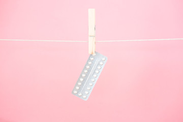 Contraceptive pill blister pack hanging from line