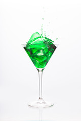 Cocktail glass with green alcohol