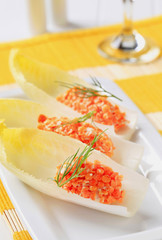 Red lentil salad on fresh endive leaves