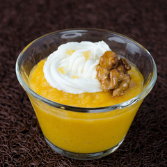 pudding with pumpkin and mango in a glass beaker