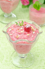 Raspberry mousse with mint and fresh raspberries closeup