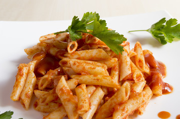 Penne pasta with a sauce of tomatoes, garlic, olive oil