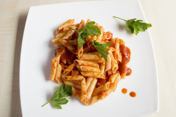 Penne pasta with a sauce of tomatoes, garlic, olive oil