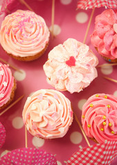Cupcukes decorated with sprinkles and frosting