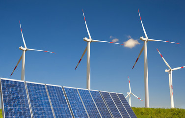 modern white wind turbine with solar paneling