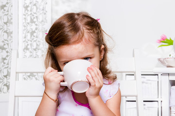 Preschool girl with a cup