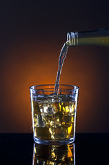 Glass of spirits on the rocks.