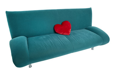 Green sofa with red heart shaped pillow lying on the couch