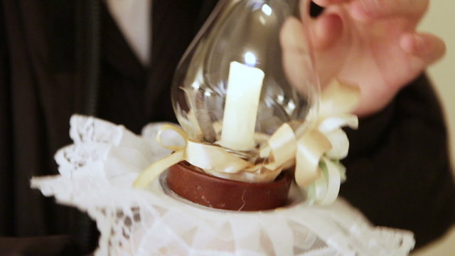Candles, glass protected witnesses at a Jewish wedding