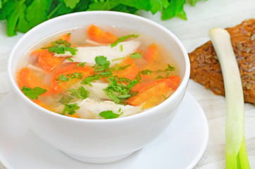 Chicken soup in white bowl