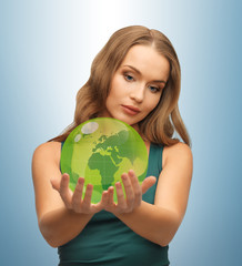woman holding green globe on her hands