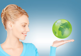 woman holding green globe on her hand