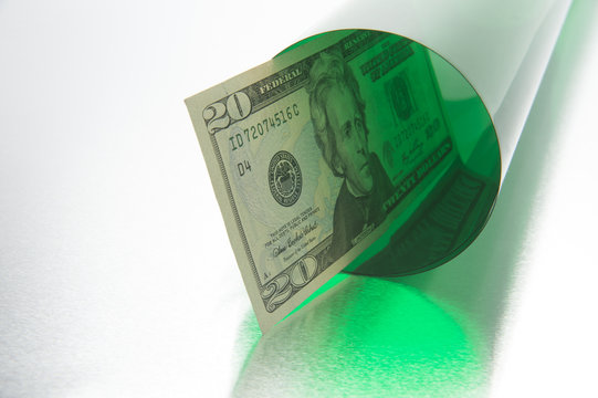 Concept photo of money going down a green tube or tunnel