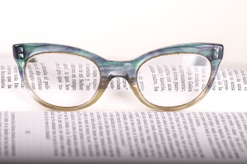 book and glasses on table