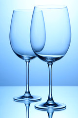Empty wine glasses arranged on blue background