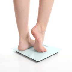 Beautiful woman legs on a scale