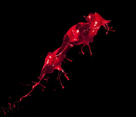 splashes of red paint isolated on black background