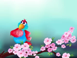Foto op Plexiglas Een papegaai aan de tak van een boom met roze bloemen © GraphicsRF