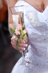 wedding glass in hands of bride