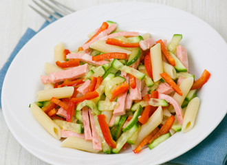 fresh vegetables salad with ham and penne pasta
