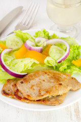 fried meat with fresh salad