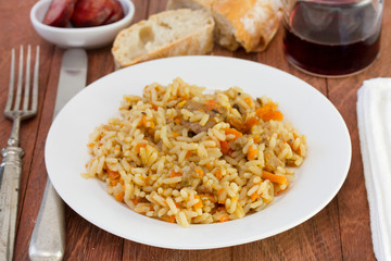 rice with vegetables and meat on the plate