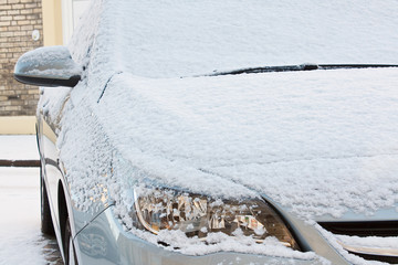 Car covered in fresh snow