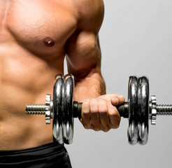 Fototapeta na wymiar powerful muscular man lifting weights