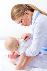 Woman therapist listening small baby heart by stethoscope