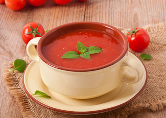 Traditional hot fresh diet tomato soup with basil