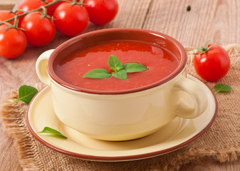 Traditional hot fresh diet tomato soup with basil