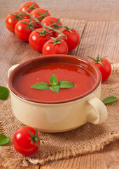 Traditional hot fresh diet tomato soup with basil