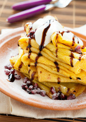 big stack of pancakes with yellow turmeric
