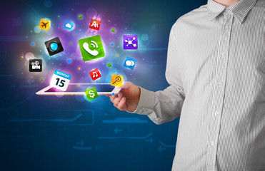 Businessman holding a tablet with modern colorful apps and icons