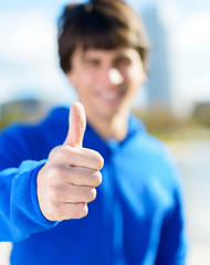 Portrait Of Young Man Showing Thumb-up Sign