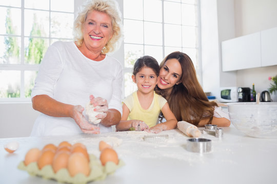 Smiling women of a family baking together