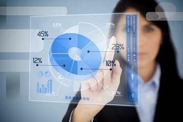 Serious businesswoman using blue pie chart interface