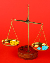 Classic scales with color pills on color background
