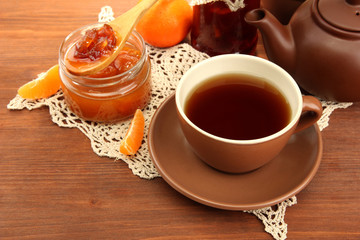 light breakfast with tea and homemade jam, on wooden table