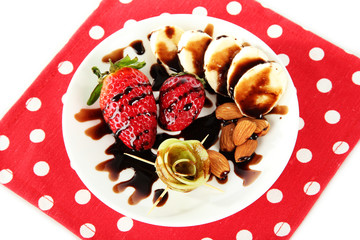 Fruit in chocolate on a red napkin polka dot
