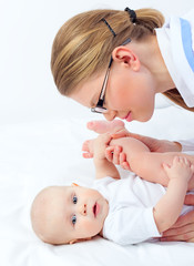 Doctor exercise small baby and massage feet