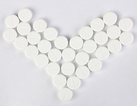 many of round pills in form of heart