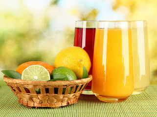 Glasses of juise with leafs and fruits