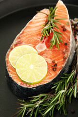 Fresh salmon steak on pan, close up
